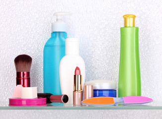 Shelf with cosmetics and toiletries in bathroom