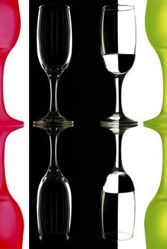 glass wine glasses on black and white background with reflection