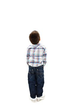 Back view of little boy looking at wall. Rear view