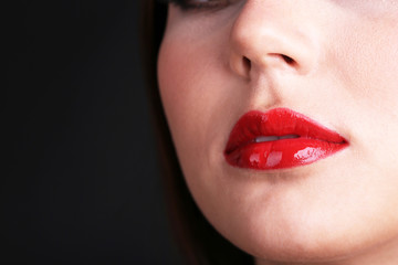 Girl with red lips on dark background