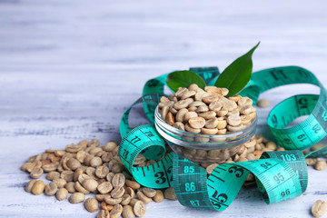 Raw green coffee beans and measuring tape,