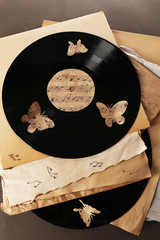 Old vinyl records with  old paper and butterflies,