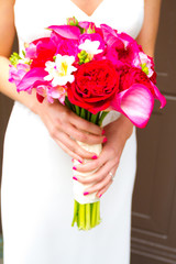 Obraz na płótnie Canvas Bride Holding Bouquet of Mixed Flowers