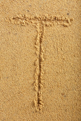 Alphabet letter written on wet beach sand