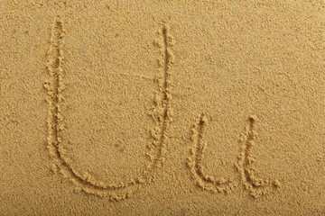 Alphabet letter written on wet beach sand