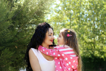 Happy mom and daughter. Walk in the green park