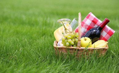 Picnic basket on green grass