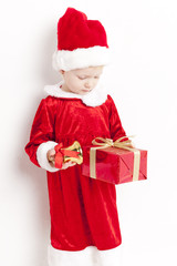 little girl as Santa Claus with a bell and Christmas present