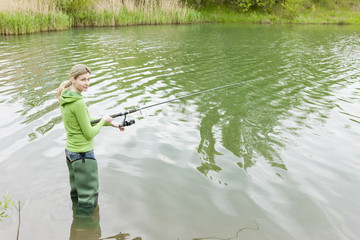 woman fishing in pond