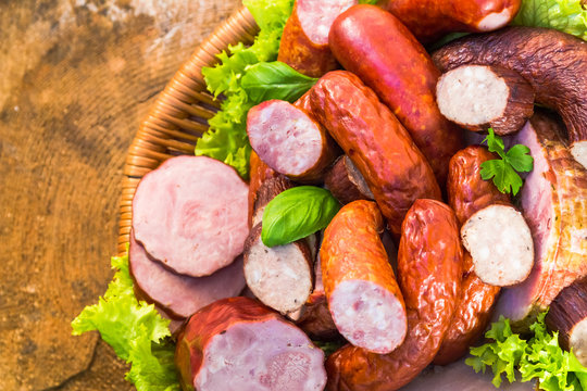 Various meat sausage basket wooden table background