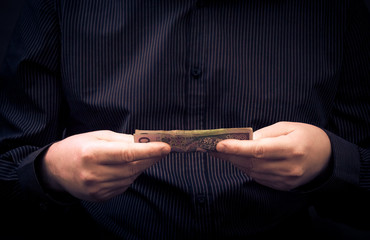 man holds hands Polish money