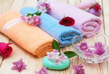 Obraz na płótnie Canvas preparing for bath, towels, soaps and flowers