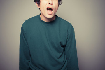 Young man pulling silly faces
