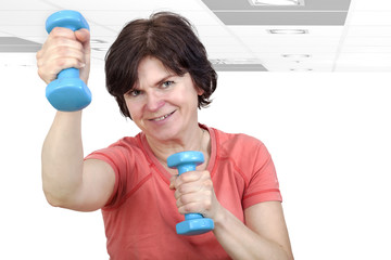 Woman with dumbbells during sport