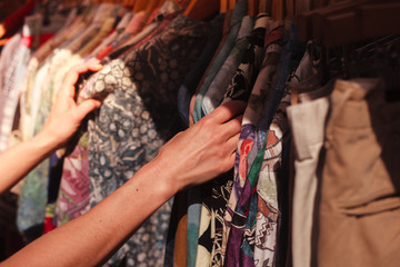 Woman browsing clothes at market - 64981868