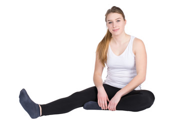 Fototapeta premium Junge Sportlerin sitzt entspannt auf dem Boden