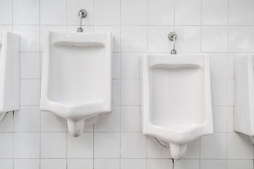 White urinals for men and boys in public toilet