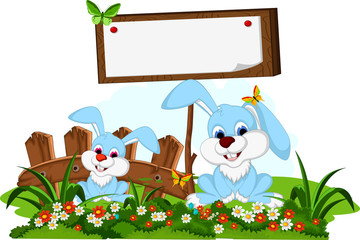 Fototapeta premium cute couple rabbit cartoon with blank board in flower garden