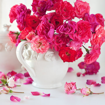 bright bouquet of a beautiful tea roses in a ceramic jug