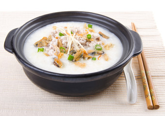 Traditional chinese pork porridge rice gruel served in claypot