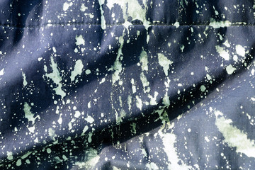 Mud splatter on blue fabric texture