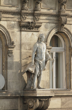Sculpture of man on building facade. Budapest, Hungary