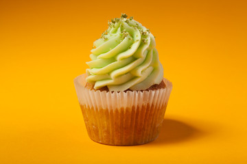 cupcake with cream isolated on orange background