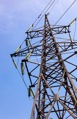 High voltage electric tower against blue sky