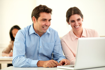 Man and woman working on laptop