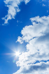 Naklejka na ściany i meble blue sky with white clouds and the sun
