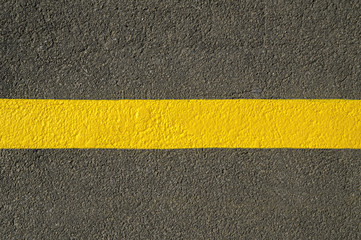 Yellow line on new asphalt detail.