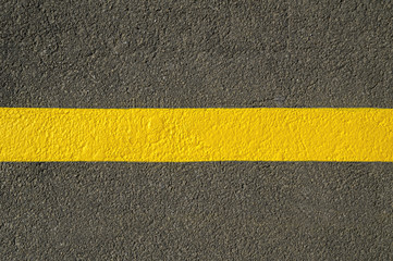 Fototapeta premium Yellow line on new asphalt detail.
