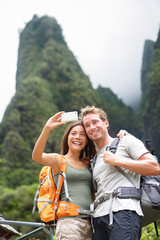 Couple taking selfie self portrait hiking, Hawaii