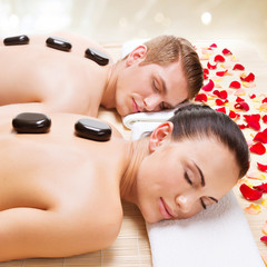 Attractive couple relaxing in spa salon.