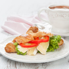 Fresh croissants with cheese on a table