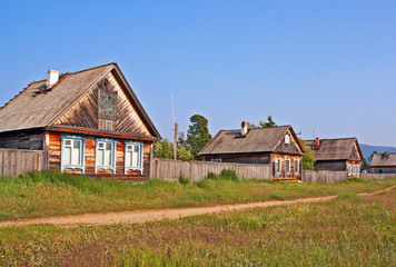 Fototapeta na wymiar Row of traditional wooden houses in a remote village in Russian