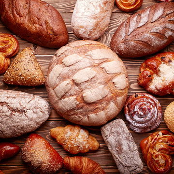 Bread and buns over wooden background