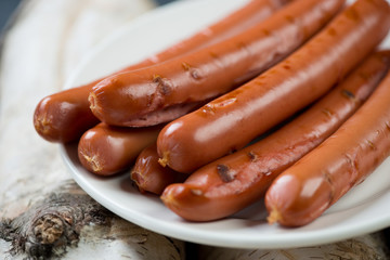 Close-up of grilled sausages on a glass plate