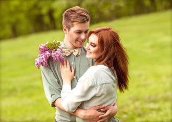 Young couple in love walking in the autumn park holding hands