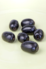 Closeup Jambolan plum on green plate