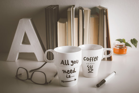 Two white coffee mug with diy decoration on vintage effect.