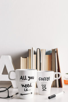 Two white coffee mug with diy decoration.