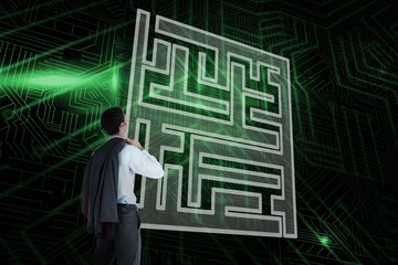Composite image of maze and businessman looking