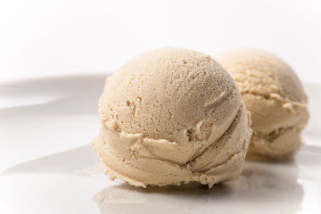 Creme brulee coffee ice cream scoop on plate white background 2