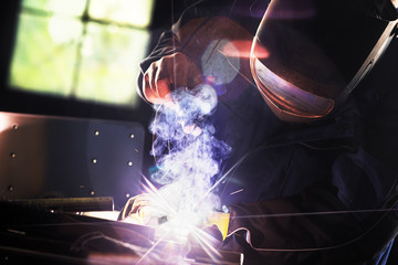 Welder With Protective Face Mask At Work