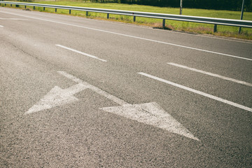 arrows on asphalt showing traffic where to go