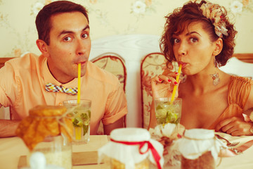 Happy marriage concept. Couple of hipsters drinking mojito