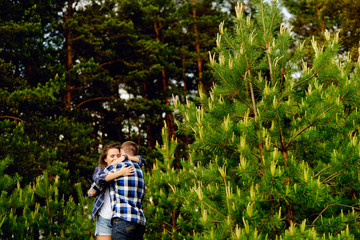 Loving couple embracing in summer forest