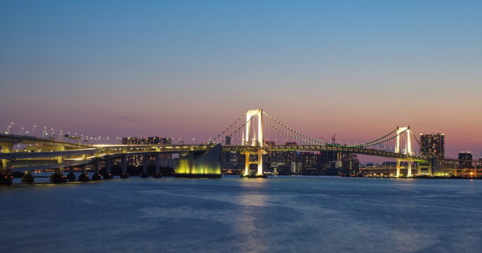 view of tokyo bay and rainbow bridge at twilight