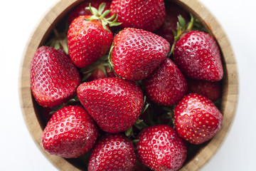 fresh red strawberries on white wooden table.